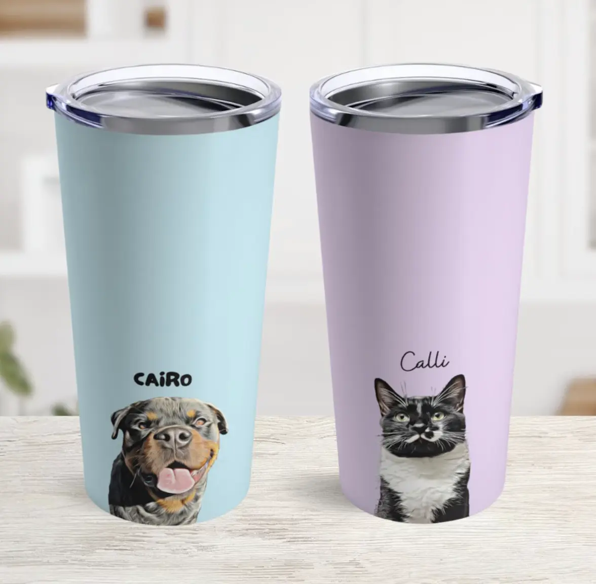 A pair of custom tumbler mugs, one in blue with a dog named CAIRO, and the other in purple with a cat named Calli.