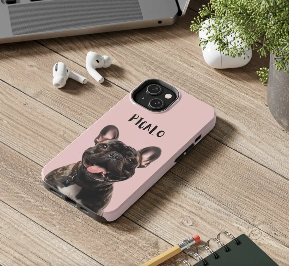 Personalized phone case with 'Picalo' the French Bulldog's image, set on an office desk.