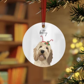 Personalized dog ornament with 'Betty' on it, hanging from a Christmas tree